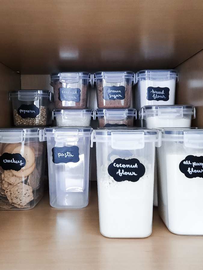 Baking supplies organized in a deep kitchen pantry