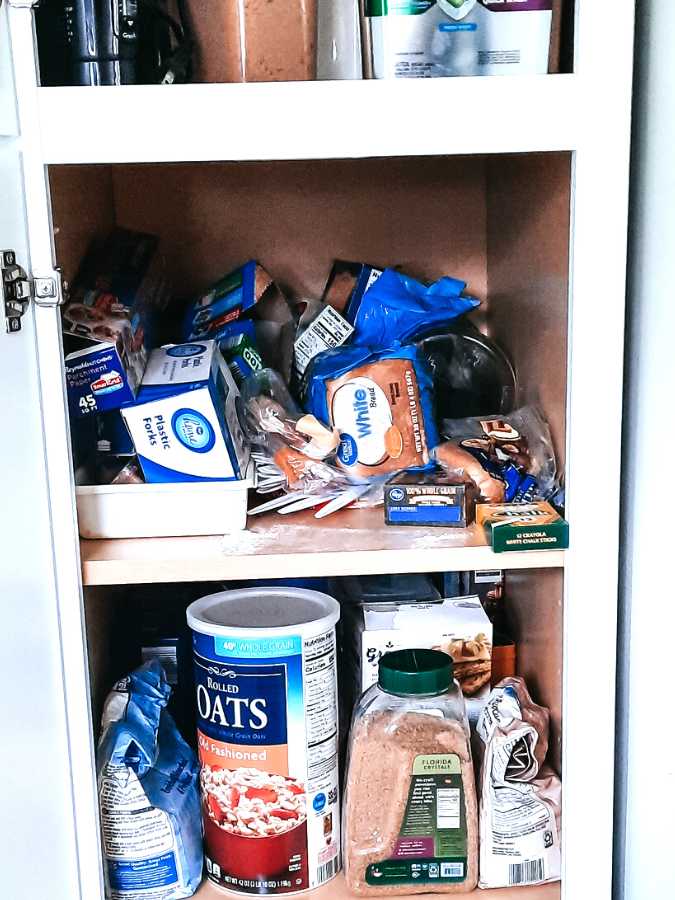 Messy and disorganized deep kitchen pantry