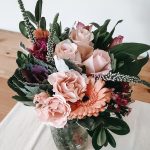 Pink floral bouquet on wooden table